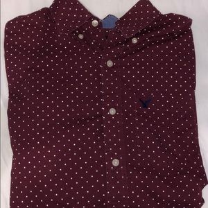 Maroon white dots shirt.